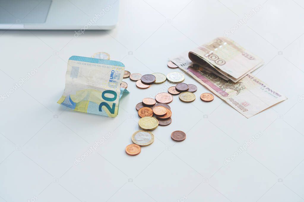 Euro money and rubles and wallet on the table