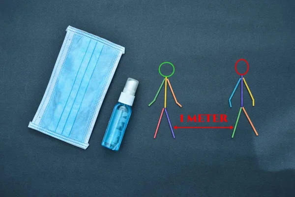 Face masks and sanitizer bottle with colorful sticks figure people with  red text \