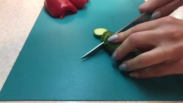 切新鲜的青黄瓜 女厨师把蔬菜切碎 中午做美味的新鲜沙拉 厨师用刀切蔬菜 切菜板上的新鲜黄瓜 — 图库视频影像