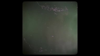 Screen of a Retro TV with scratches and damage. Black and white screen with rounded edges and damaged film tape.