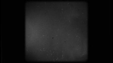 Screen of a Retro TV with scratches and damage. Black and white screen with rounded edges and damaged film tape.