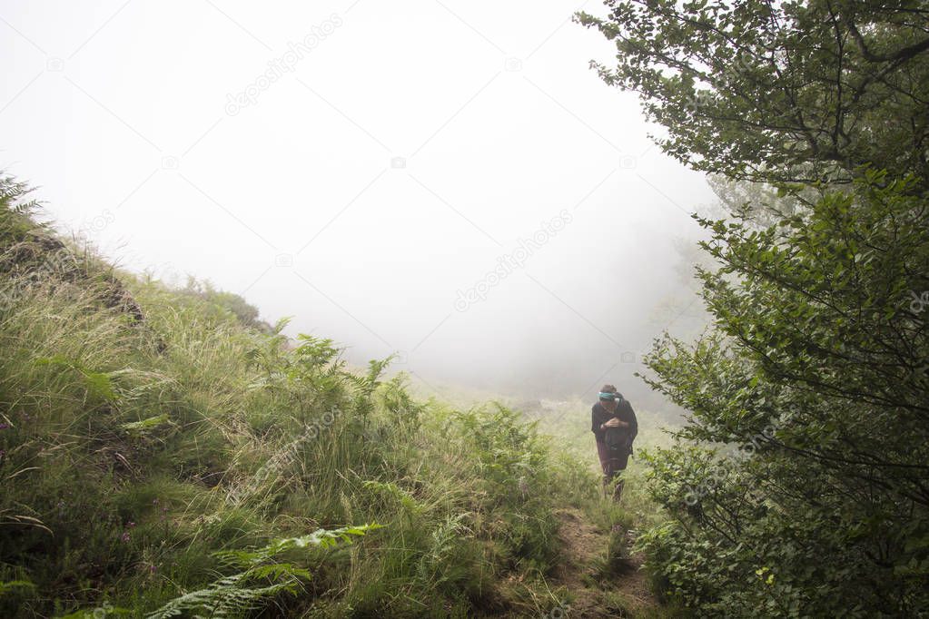 Woman  in green Forest in fog