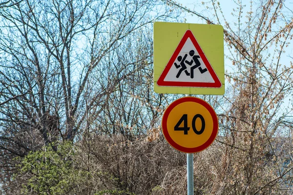 Road sign Caution children and speed limit 40.