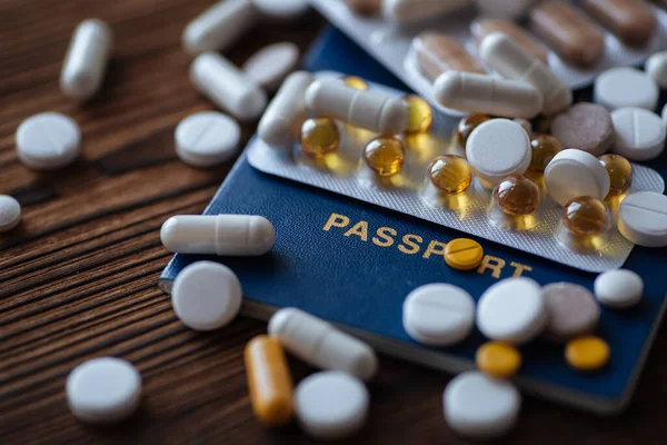 A pills, passport on a wooden background