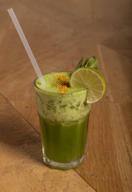 Yeşil detoks suyu, kireç ve nane şekerli ahşap masa. sağlıklı konsept