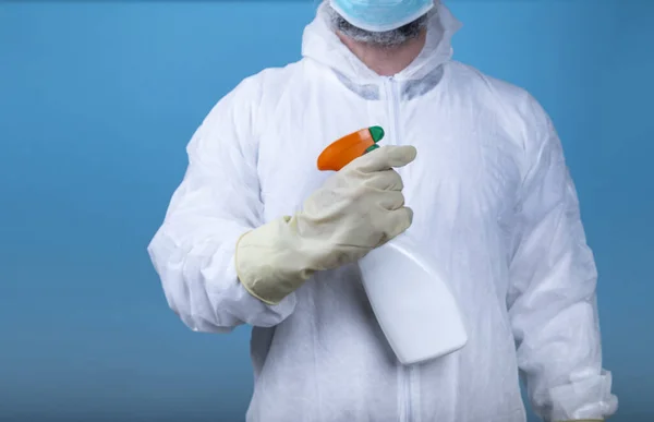 Man Protective Suit Mask Holding Bottle Disinfectant Spray Blue Background — Stock Photo, Image