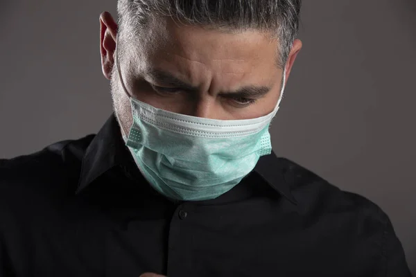 Portrait Downcast Man Medical Protection Mask Gray Studio Background Coronavirus — Stock Photo, Image