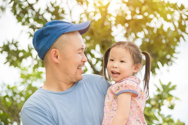 Girl with her father in the garden — Stock Photo, Image