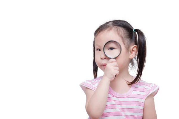 Little girl looking through magnifying glass — Stock Photo, Image