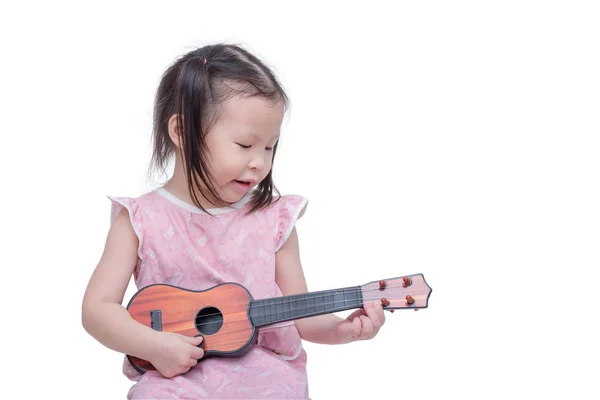 Little girl playing guitar toy Stock Picture