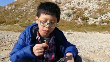 Genç çocuk bir sosis yeme 