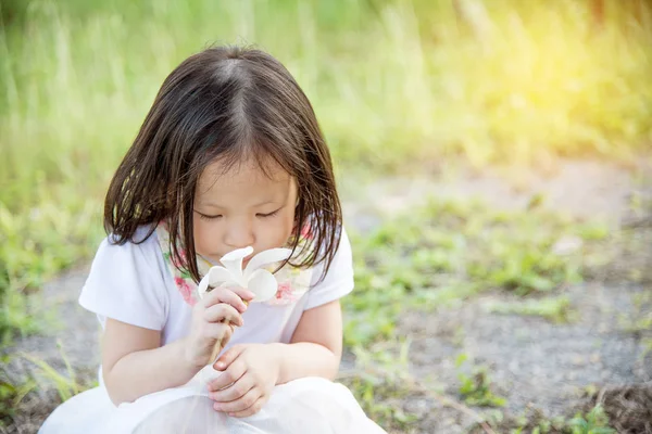 Mädchen riecht Blume im Park — Stockfoto