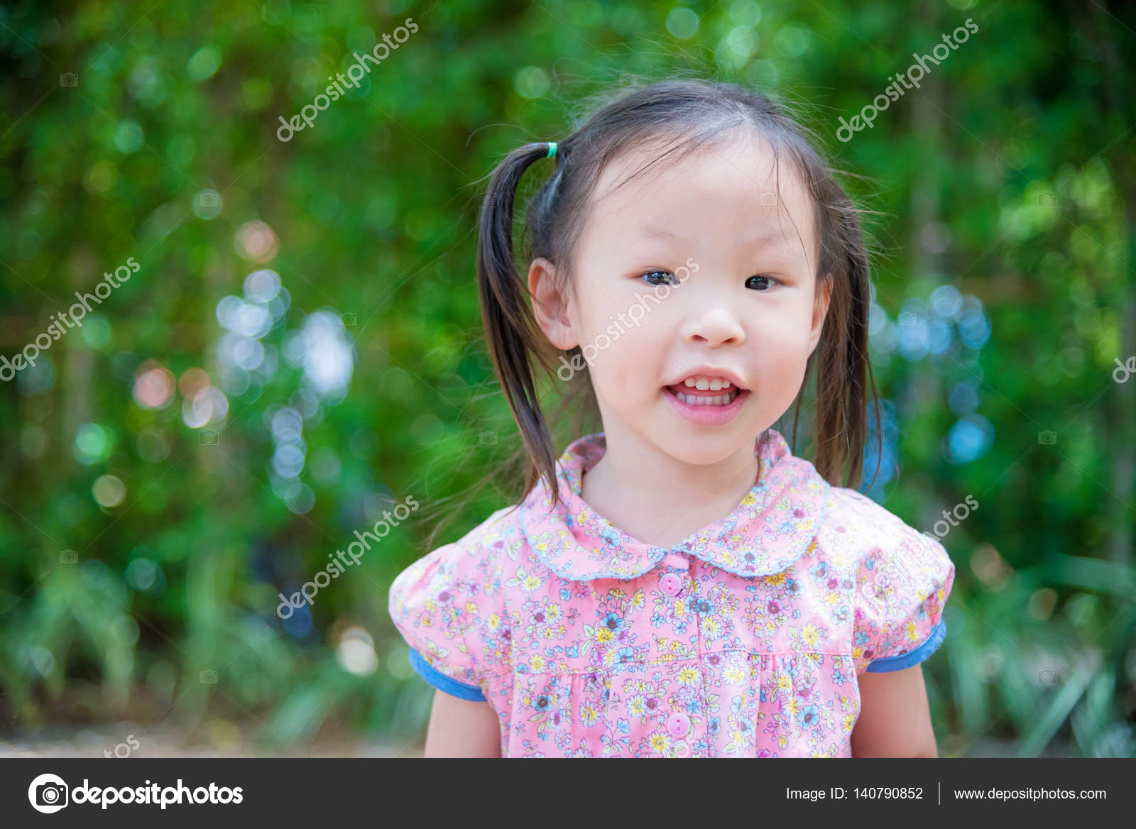 Girl smiling in park Stock Photo by ©parinyabinsuk 140790852