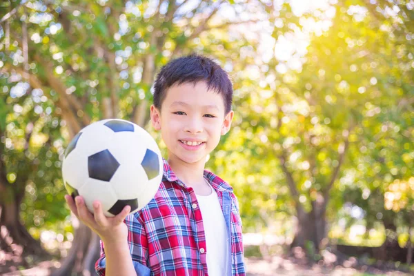 Boy with ball in park — Stock Photo, Image