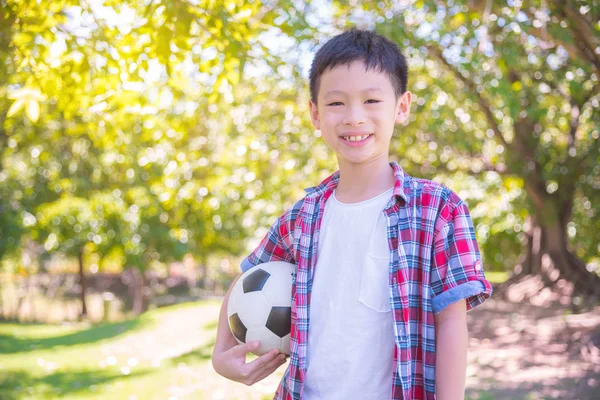 boy with ball in park