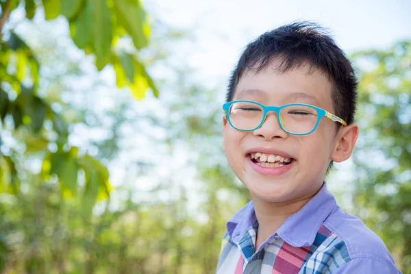 Menino sorrindo no parque — Fotografia de Stock