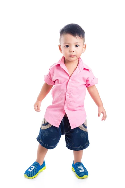 Little boy wearing pink shirt standing over white background — Stock Photo, Image