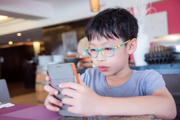 Çocuk cep telefonu oyunları oynarken yüz stres yapıyor — Stok fotoğraf