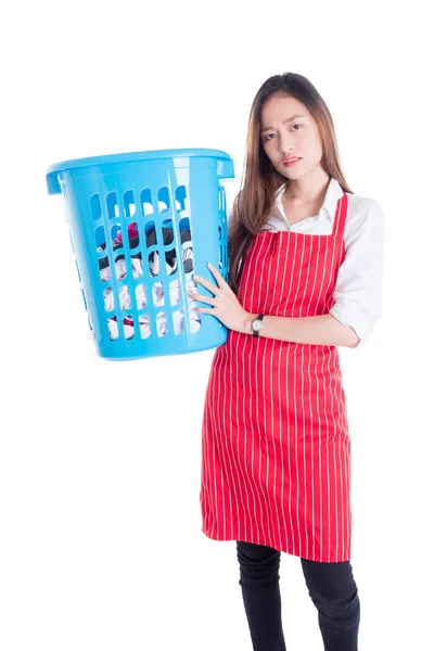 Уставшая азиатка в красном фартуке и с одеждой в руках — стоковое фото