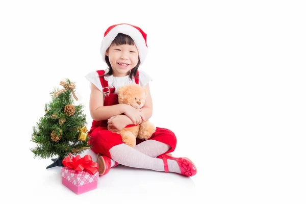 Meisje dragen santa jurk zittend op de vloer — Stockfoto