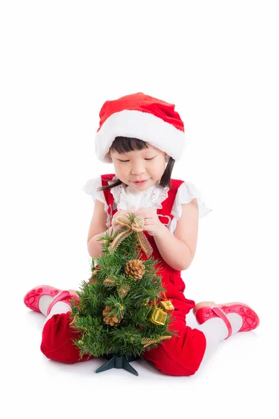 Meisje dragen santa jurk zittend op de vloer — Stockfoto