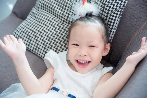 Little girl wearing white color dress lying and smi — Stock Photo, Image