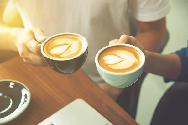 Couple hands holding coffee cup with — Stock Photo, Image