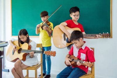 Genç Asyalı çocuklar müzik aletleri müzik sınıf oyun