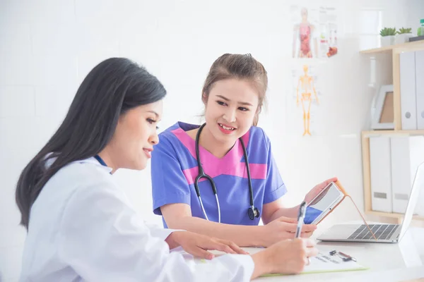 nurse meeting with doctor in hospital