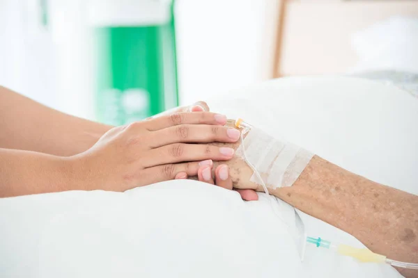 Enfermeira segurando a mão paciente sênior — Fotografia de Stock