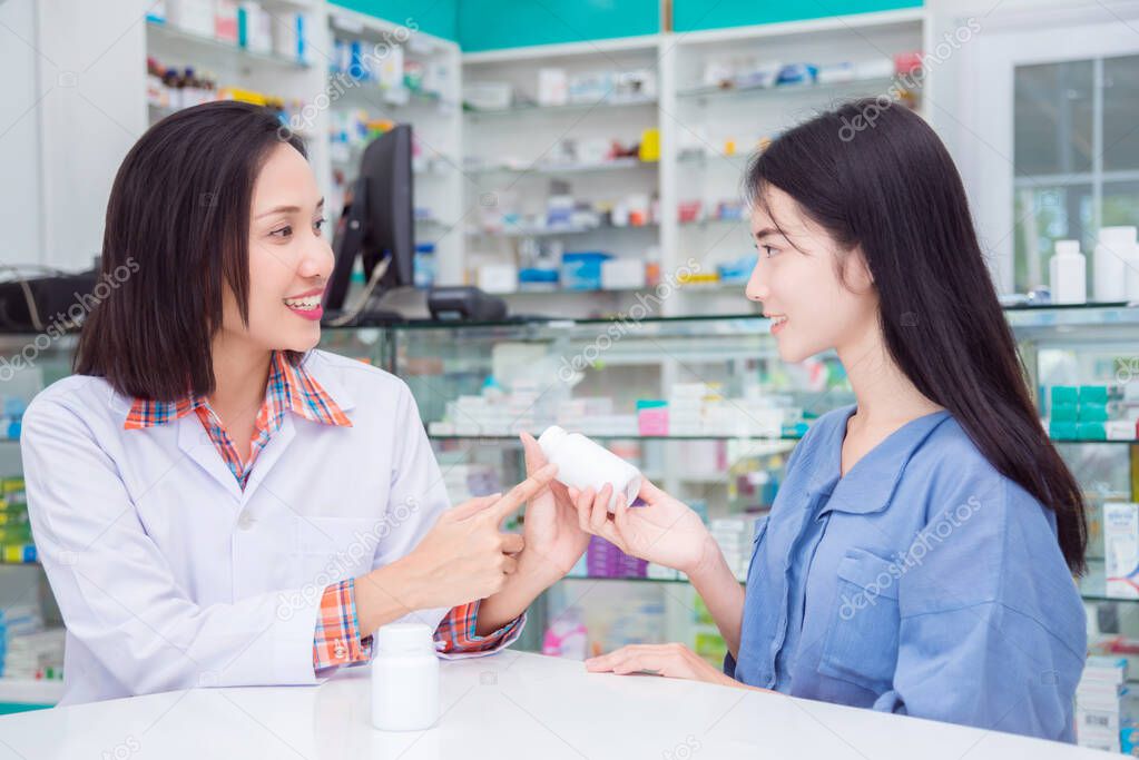 Beautiful pharmacist giving drug information to patient 
