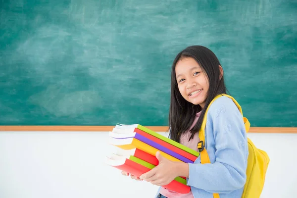 Young Asian Female Student Holding Many Books Smiles Front Green — Stock Photo, Image