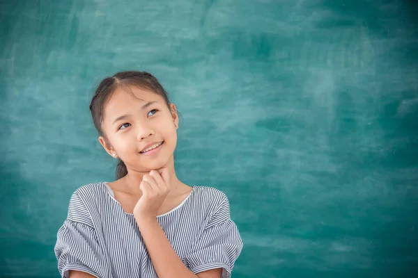 Young Asian Female Student Thinking Smiles Front Green Chalkboard Background — Stock Photo, Image