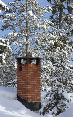 Chimney on snowy roof clipart