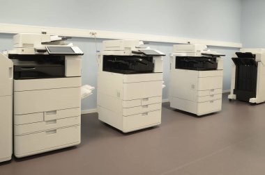 Room with photocopier machines. clipart