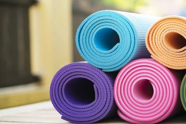 Крупним планом барвистий йога килимок на столі, спорт і здоровий співробітник — стокове фото