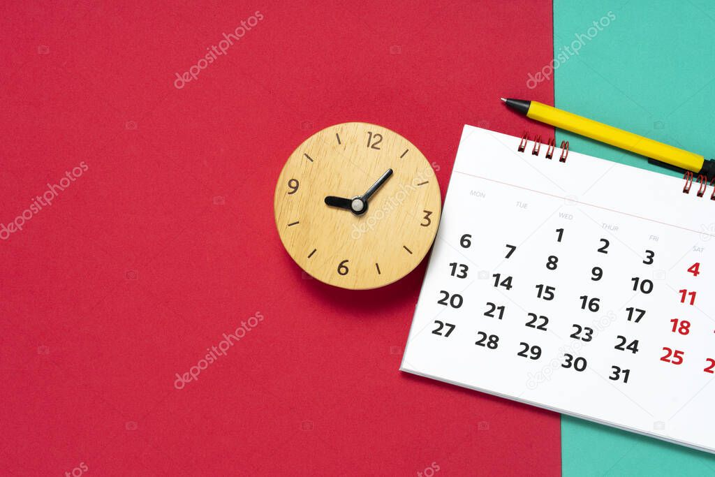 close up of calendar and alarm clock on the table, planning for business meeting or travel planning concept
