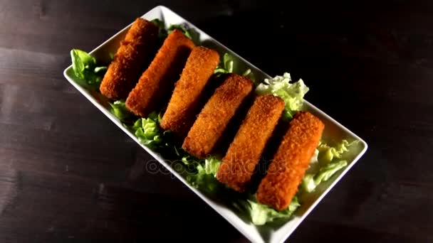 Fish sticks on tray which rotate counter-clockwise when viewed from above — Stock Video