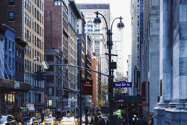 NEW YORK, NY- 03 December, 2016: Manhattan (New York) street with yellow cabs and architecture, East 34th St