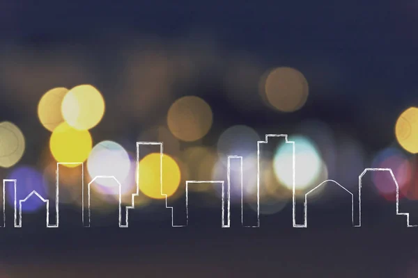 City skyline outline over night light bokeh — Stock Photo, Image