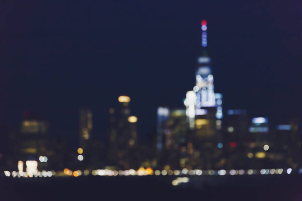 Bokeh of Manhattan's skyline in New York from across the Hudson, blurred unfocused background with slightly faded tones