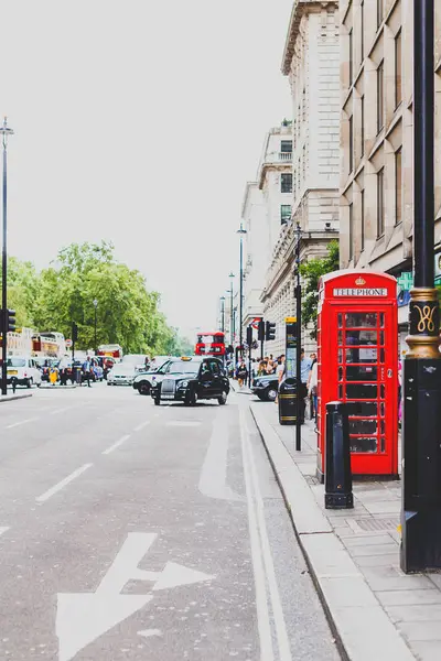 通りのボケ味を持つロンドン市内中心部の赤い電話ボックス — ストック写真