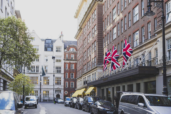 LONDON, UNITED KINGDOM - August 2nd, 2014: beautiful streets with historical buildings in Mayfair, an affluent are of London city centre featuring The May Fair hotel