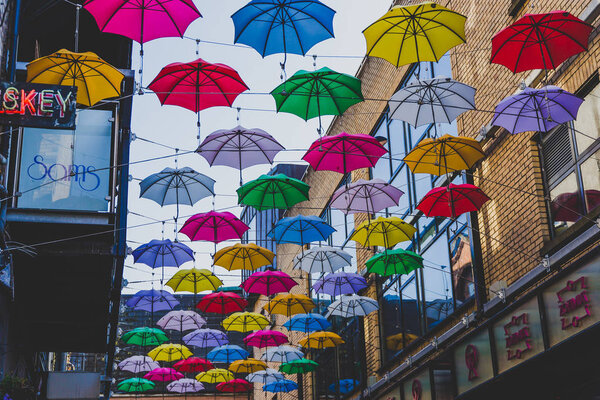 colorful umbrellas art installation in frot of the Zozimus bar i