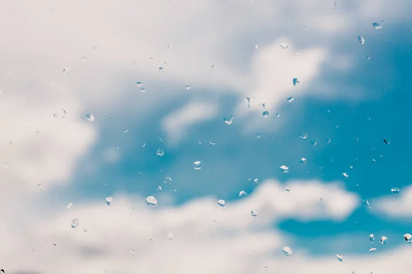 Raindops su vetro di finestra con bokeh di cielo azzurro sereno con pochi — Foto Stock