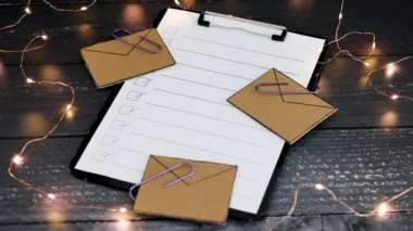 productivity and business schedules conceptual video, hand placing pencil next to email icons on top of to do list on clipboard
