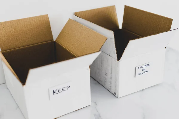 Deluttering concept, storage boxes to sort between objects to k — Stock fotografie