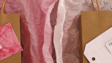 original product vs dupe imitation label on shopping bags with similar color paper and camera zooming out to reveal the scene, concept of competition and knock-off items