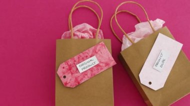 original product vs dupe imitation label on shopping bags with similar color paper and camera zooming in on the original one, concept of competition and knock-off items