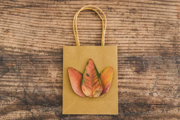 Paper bags with leaves on them symbol of a more ecological alter — Stock Photo, Image